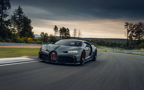 A sleek Bugatti Chiron Pur Sport supercar speeds along a track, captured in stunning 4K Ultra HD for a dynamic PC desktop wallpaper.