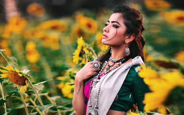 HD desktop wallpaper featuring a woman amidst sunflowers, offering a vibrant background setting for screens.
