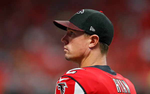 HD desktop wallpaper featuring a profile view of a person wearing a black cap and red Falcons jersey.