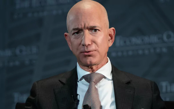 HD desktop wallpaper featuring a man in a suit with a striped tie speaking at an event, tagged as Jeff Bezos.