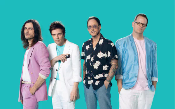 HD wallpaper featuring the band Weezer, with members posing against a teal background.