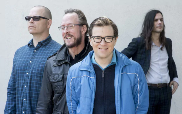 HD wallpaper featuring the band Weezer, with members lined up and posing for the camera.