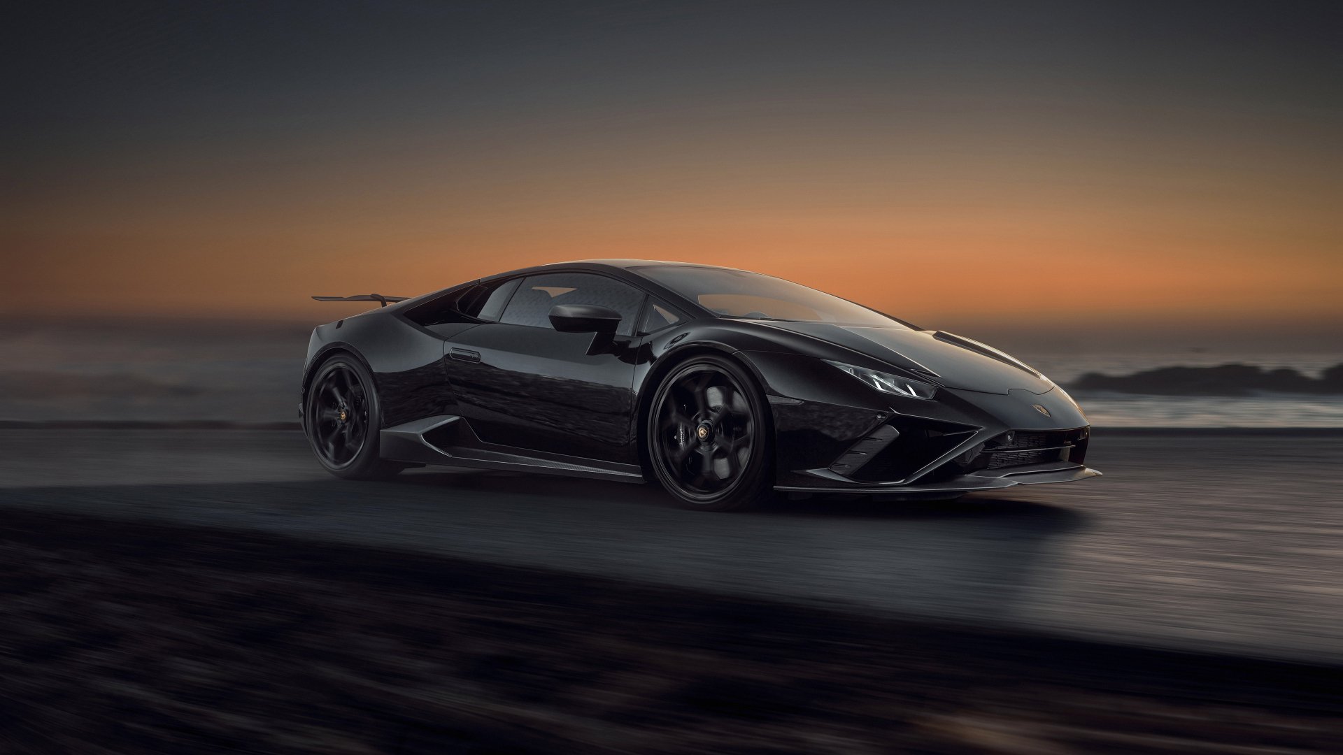 4K Ultra HD desktop wallpaper of a black Lamborghini Huracan Evo supercar on a coastal road at dusk.