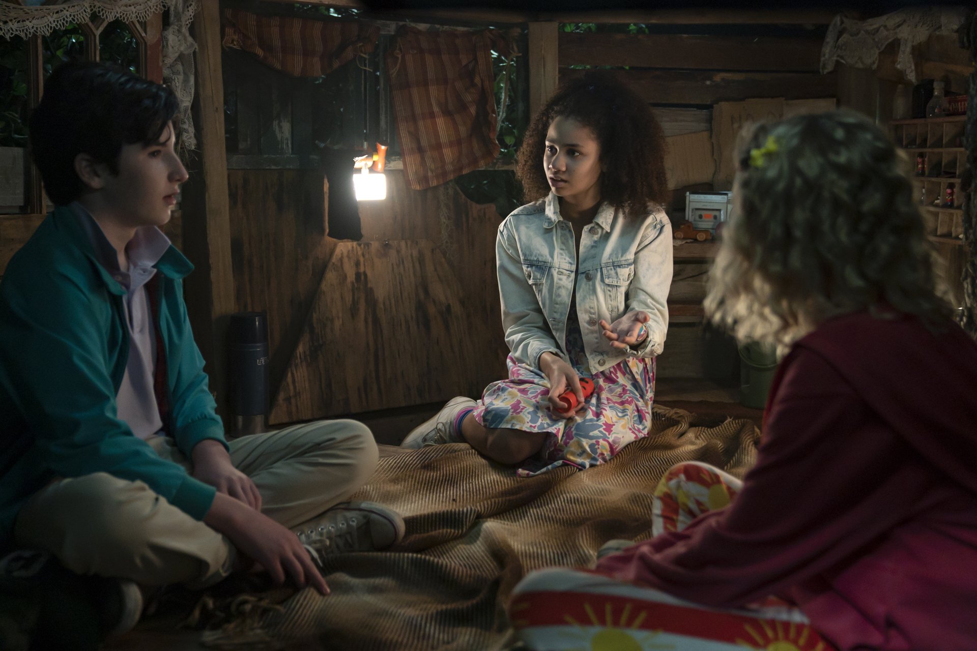 HD desktop wallpaper from Secrets Of Sulphur Springs featuring three characters having a conversation by candlelight.