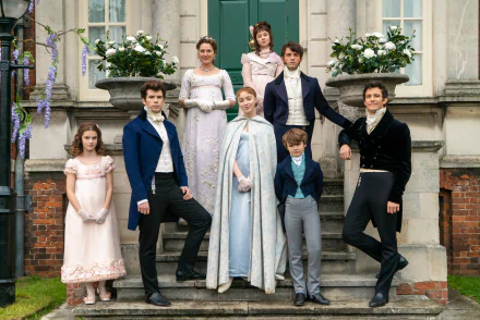 HD desktop wallpaper of Bridgerton cast posing in period costumes in front of an elegant mansion.