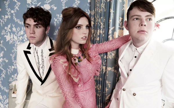 Echosmith band members posing in stylish outfits, with Sydney Sierota in the center, as a HD desktop wallpaper.