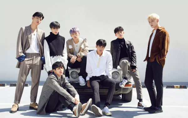 HD desktop wallpaper featuring the K-pop group iKON, with members posing stylishly beside a vintage car under a clear sky.