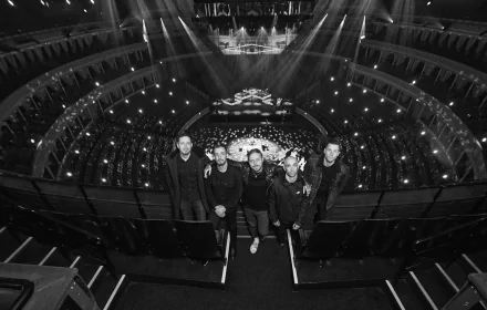 HD desktop wallpaper featuring a group of architects standing confidently in an impressive, well-lit amphitheater setting.
