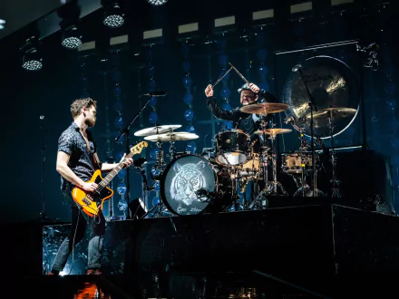 HD desktop wallpaper featuring two members of Royal Blood performing live on stage, with one playing the guitar and the other on drums, set against a dark concert backdrop.