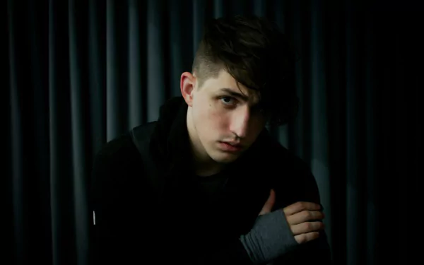 HD wallpaper featuring a reflective individual against a dark, draped background, tagged with Porter Robinson.