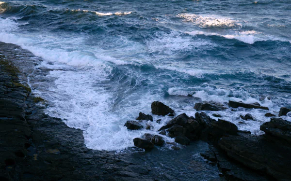  Sea waves hitting rocks on the shore