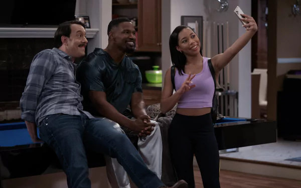 Jamie Foxx shares a fun moment on the set of Dad Stop Embarrassing Me, posing for a selfie with co-stars, capturing the show's comedic spirit in vibrant HD detail.