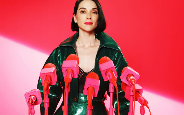 HD desktop wallpaper featuring a styled individual in a green jacket surrounded by pink microphones against a vibrant red background, tagged with St. Vincent.