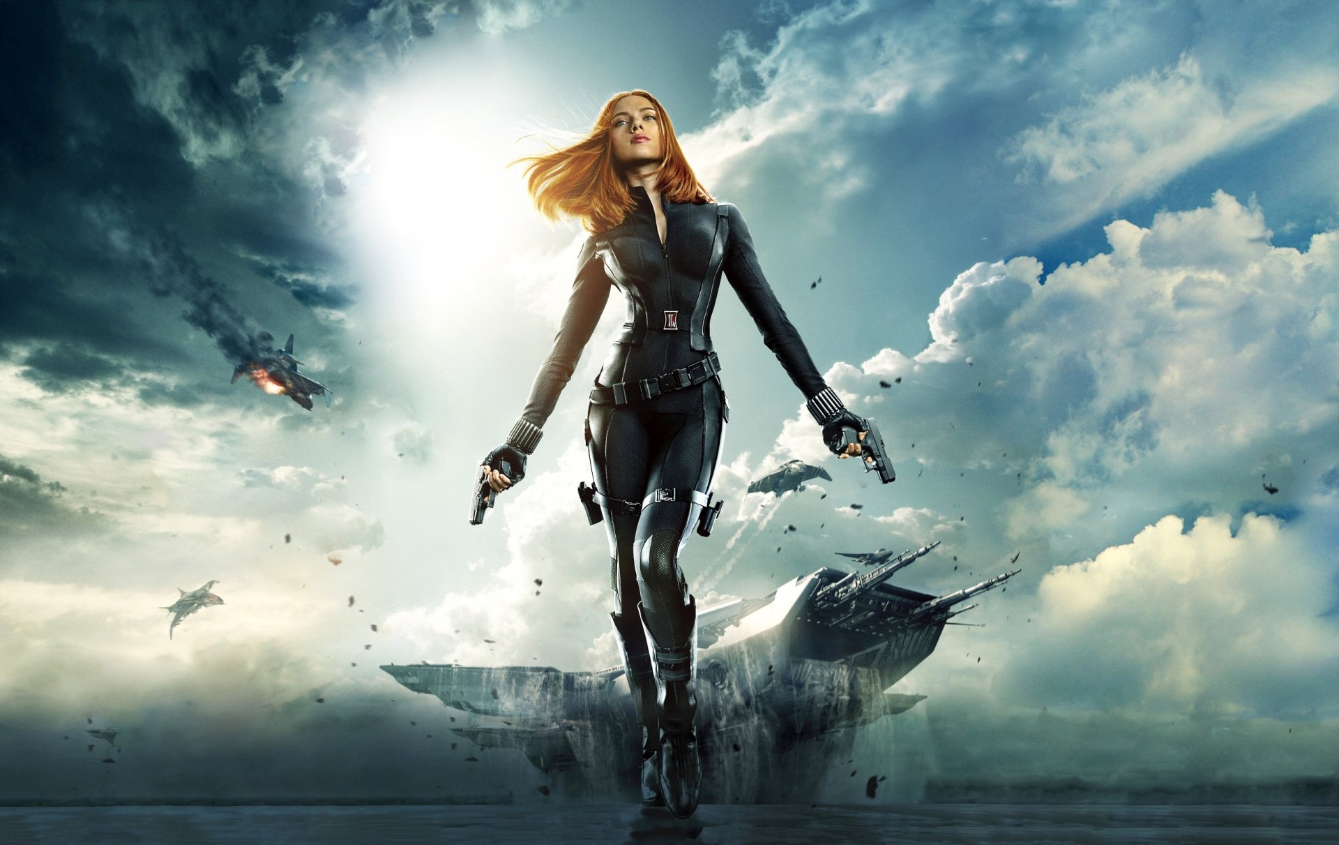 HD desktop wallpaper featuring Scarlett Johansson as Black Widow from the movie Captain America: The Winter Soldier, standing confidently with guns amid a dramatic sky.