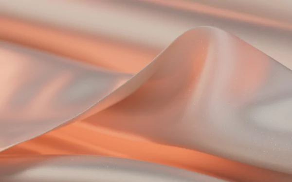 Windows 11 abstract liquid 2K Quad HD PC desktop wallpaper showing flowing peach and cream silk-like waves with soft glossy folds.