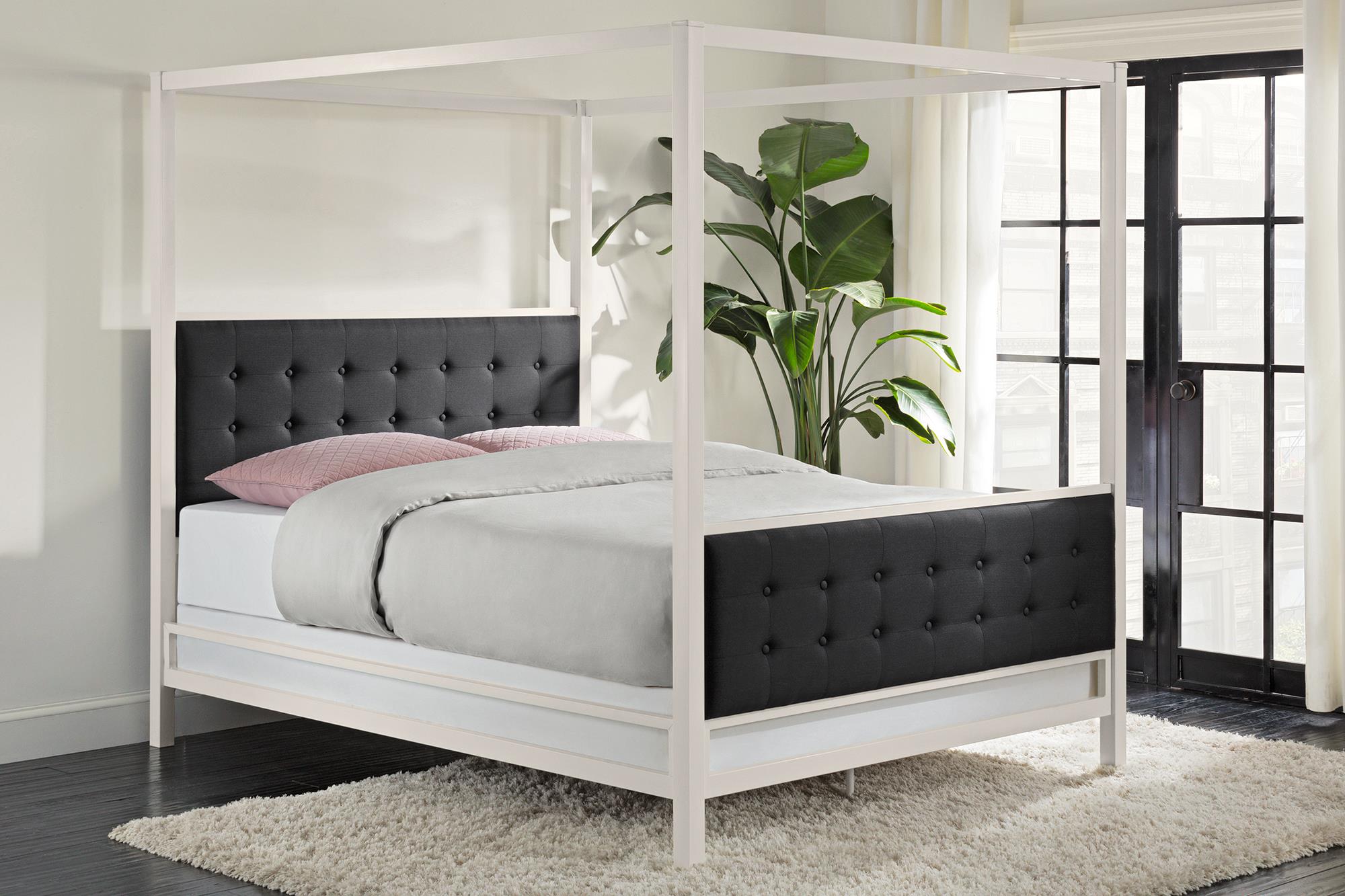 Elegant modern bedroom with a white four-poster bed, stylish black headboard, and cozy bedding, perfect for a chic HD desktop wallpaper background.