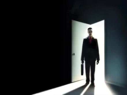 HD PC desktop wallpaper featuring the G-Man from the Half-Life video game series, with light streaming from an open door behind him, capturing the eerie atmosphere of Half-Life 2.
