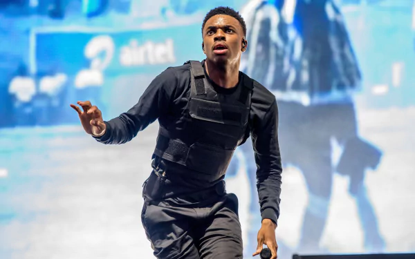 HD wallpaper of a dynamic performance moment for desktop background, tagged with a musical artist.