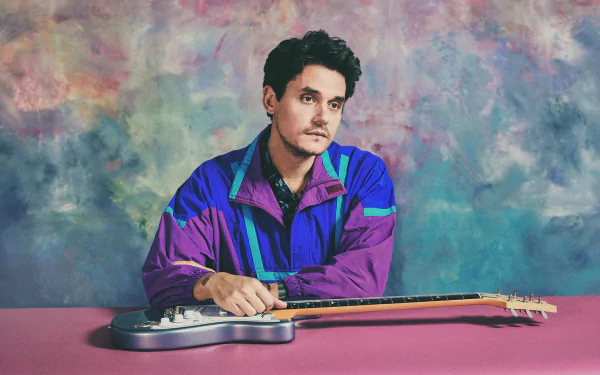 HD desktop wallpaper featuring a musician with a guitar on a colorful abstract background.