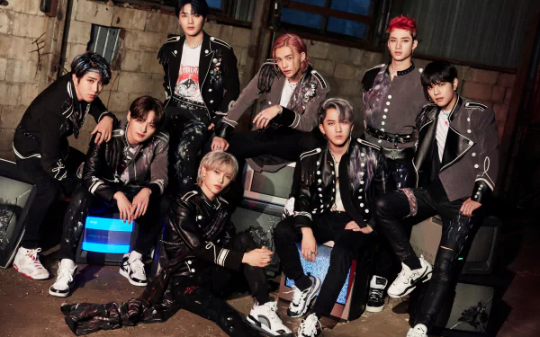HD PC desktop wallpaper featuring Stray Kids, a K-pop boy band, posing together in stylish outfits against an industrial backdrop.