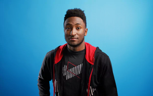 HD desktop wallpaper featuring a person with a red hoodie and black jacket against a blue background.