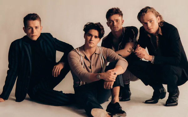 HD wallpaper of The Vamps, featuring the band members dressed in black, posed against a neutral backdrop for desktop background.