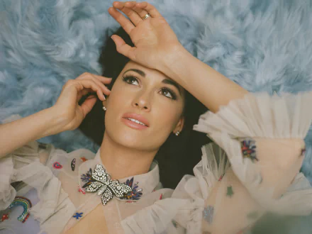 Elegantly dressed woman lying on a blue fluffy background, posing thoughtfully for an artistic HD desktop wallpaper.