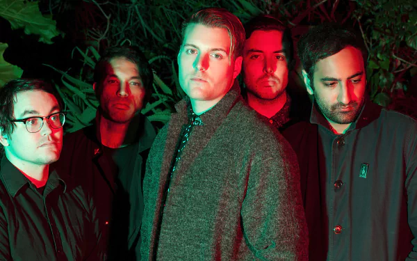 HD wallpaper featuring a group of five male band members posing with a red-toned backlight in a foliage setting, tagged with Deafheaven.