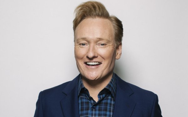 HD desktop wallpaper of smiling man in blue suit and plaid shirt, suitable for Conan O'Brien fans.