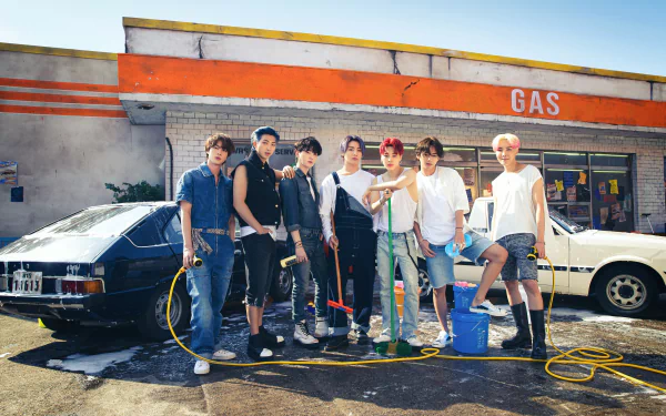 BTS members RM, Suga, Jin, J-Hope, Jimin, V, and Jungkook pose together in front of a gas station, captured in a 4K Ultra HD K-pop music desktop wallpaper.