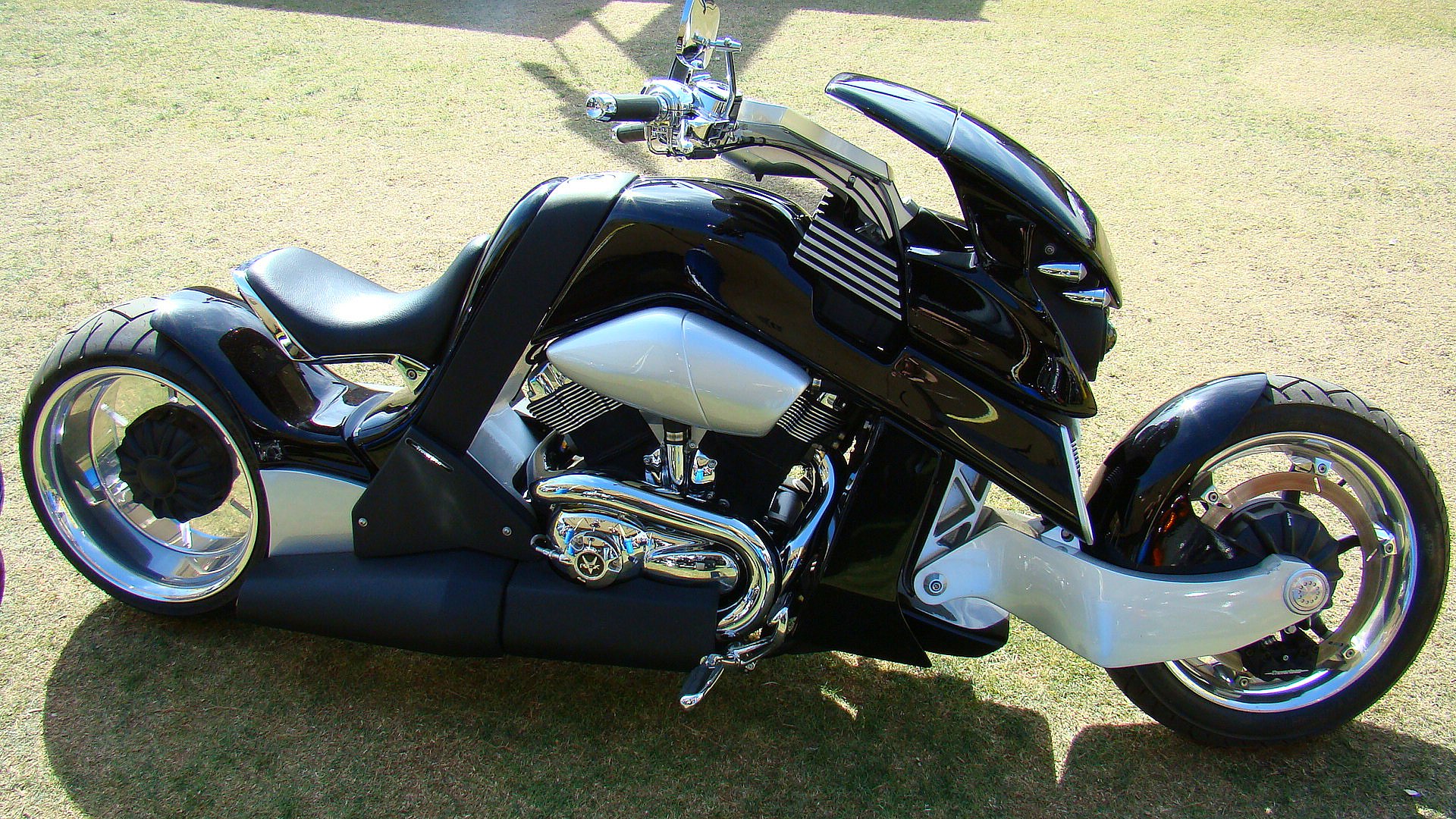 A sleek black motorcycle on a open road, ready for a thrilling ride.