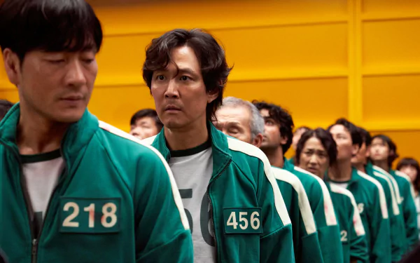 HD PC desktop wallpaper featuring Squid Game characters Ali, Oh Il-nam, Cho Sang-Woo, and Seong Gi-Hun from the popular TV show.