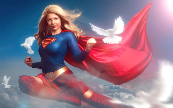 Supergirl cosplay (DC Comics): woman in blue-and-red suit with flowing cape and white doves over clouds — 8K Ultra HD PC desktop wallpaper/background.