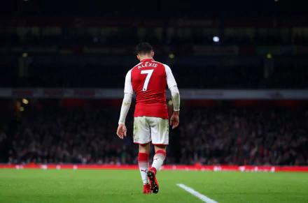 HD PC desktop wallpaper featuring footballer Alexis Sánchez wearing a red and white sports jersey with number 7, walking on a stadium field.