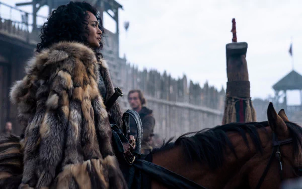 HD PC desktop wallpaper for the TV show Vikings: Valhalla — fur-clad warrior woman on horseback before a wooden fort under an overcast sky.
