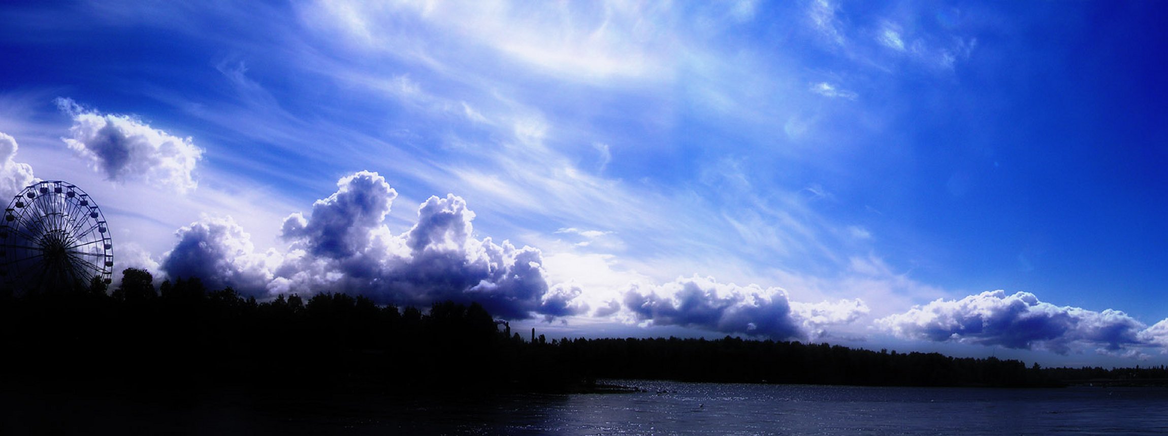Scenic view of sky reflecting on a calm lake with fluffy clouds