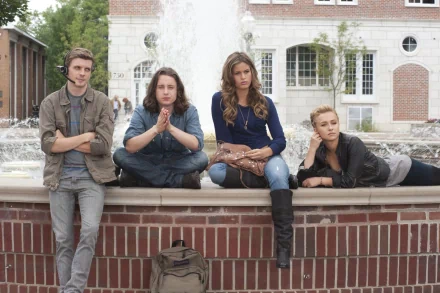 Scream 4 movie scene showing four characters sitting by a fountain in a courtyard. The image is in HD quality, making it an excellent desktop wallpaper and background.