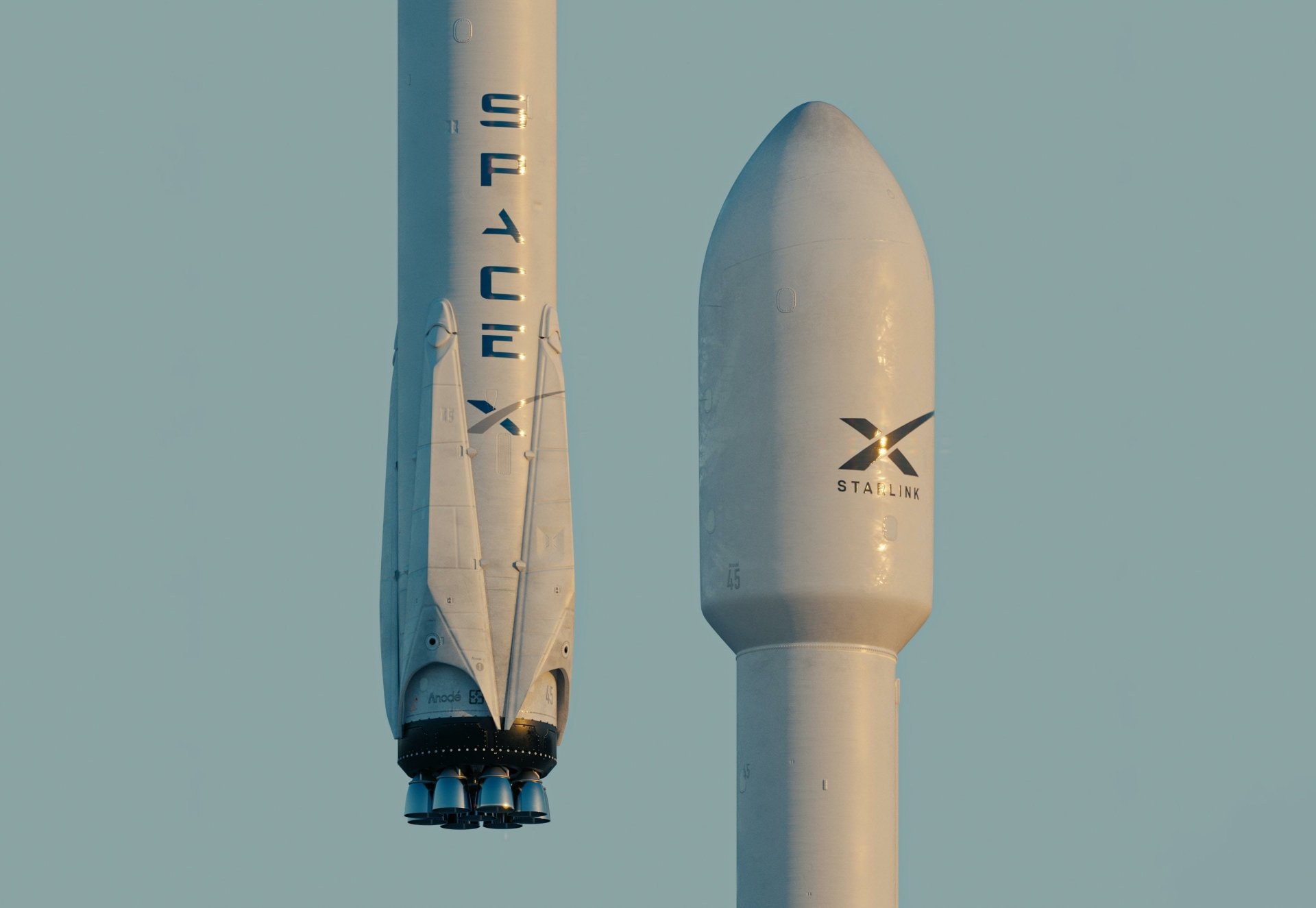 2K Quad HD PC desktop wallpaper: man-made SpaceX rocket first stage and payload fairing close-up against a pale sky.