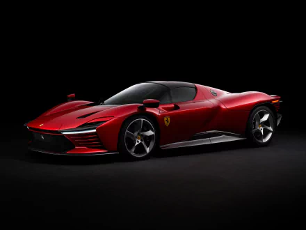 Red Ferrari Daytona SP3 on a black studio backdrop, 2K Quad HD PC desktop wallpaper/background.