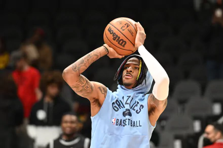 HD PC desktop wallpaper featuring NBA player Ja Morant in a Memphis Grizzlies practice jersey, focused on taking a basketball shot during warm-up.