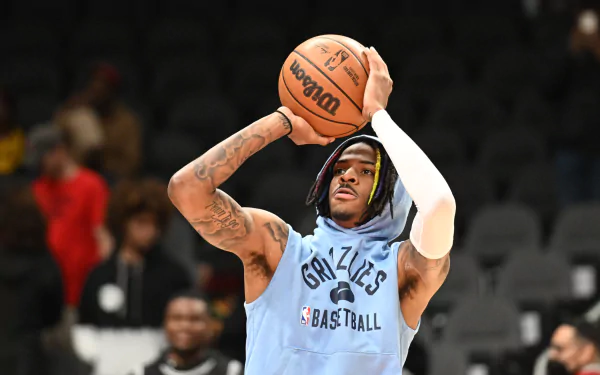 HD PC desktop wallpaper featuring NBA player Ja Morant in a Memphis Grizzlies practice jersey, focused on taking a basketball shot during warm-up.