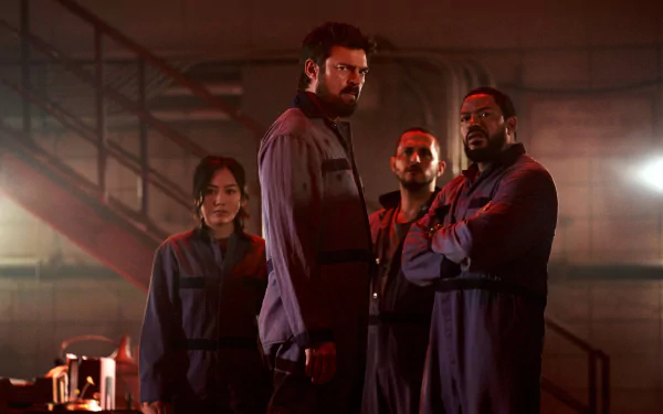 Four characters from the TV show The Boys (2019) in coveralls under red industrial lighting, posed in a dim factory — 2K Quad HD PC desktop wallpaper/background.