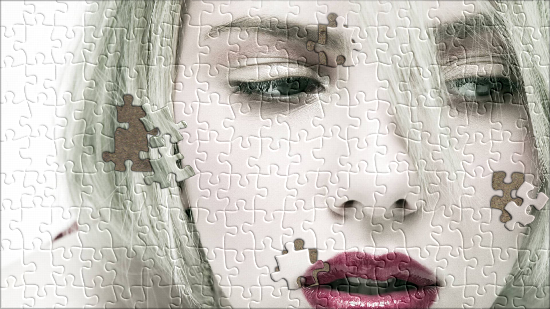 Scarlett Johansson puzzle wallpaper: A stunning celebrity image with puzzle pieces artfully arranged.