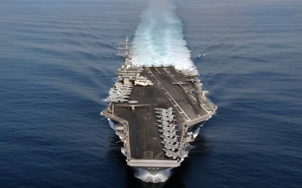 A stunning HD wallpaper of the USS Ronald Reagan (CVN-76), an aircraft carrier, cruising through calm ocean waters, showcasing its military strength and capabilities.