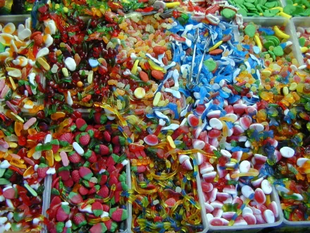 HD desktop wallpaper featuring an assortment of colorful gummy bears and various candies, creating a vibrant and appetizing background.