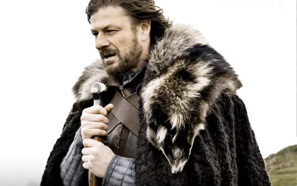 HD desktop wallpaper featuring Sean Bean as Eddard Stark from the TV show Game of Thrones, dressed in a fur cloak and holding a sword.