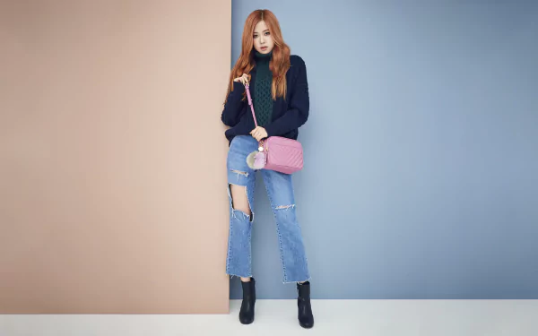 HD desktop wallpaper of Rosé from BlackPink, posing stylishly in casual attire against a two-tone beige and blue backdrop, highlighting her music star presence.