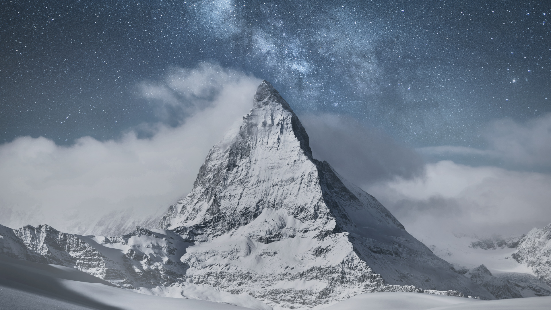 Snow-covered Matterhorn peak in Switzerland under a starry night sky, captured in stunning 4K Ultra HD for a vivid nature desktop wallpaper.