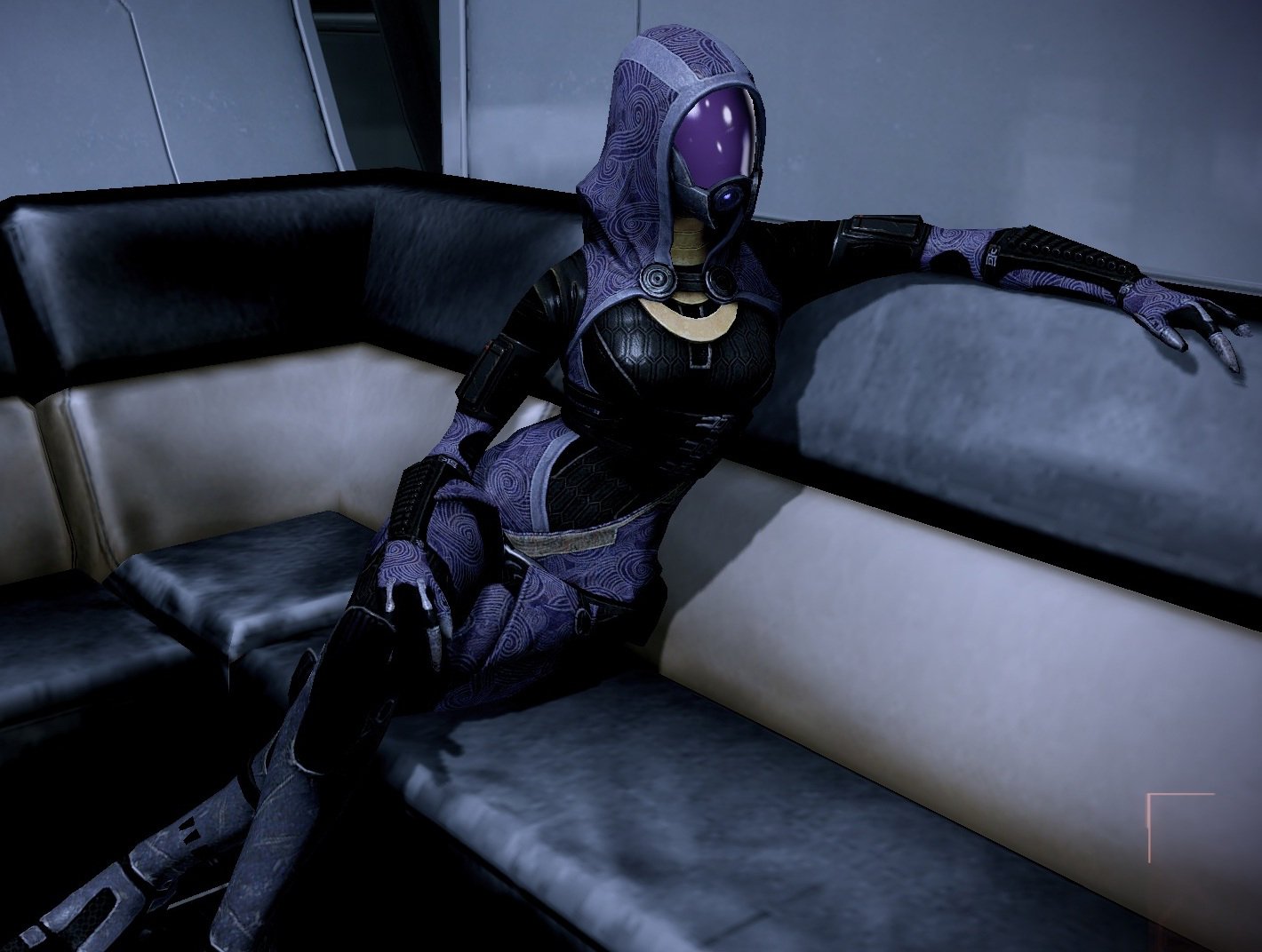 Tali'Zorah from Mass Effect 2 relaxes on a sleek couch in this HD desktop wallpaper, embodying the mysterious allure of the iconic video game series.