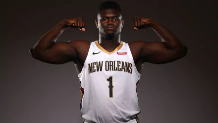 HD desktop wallpaper featuring a person in a New Orleans basketball jersey flexing muscles with a confident expression.
